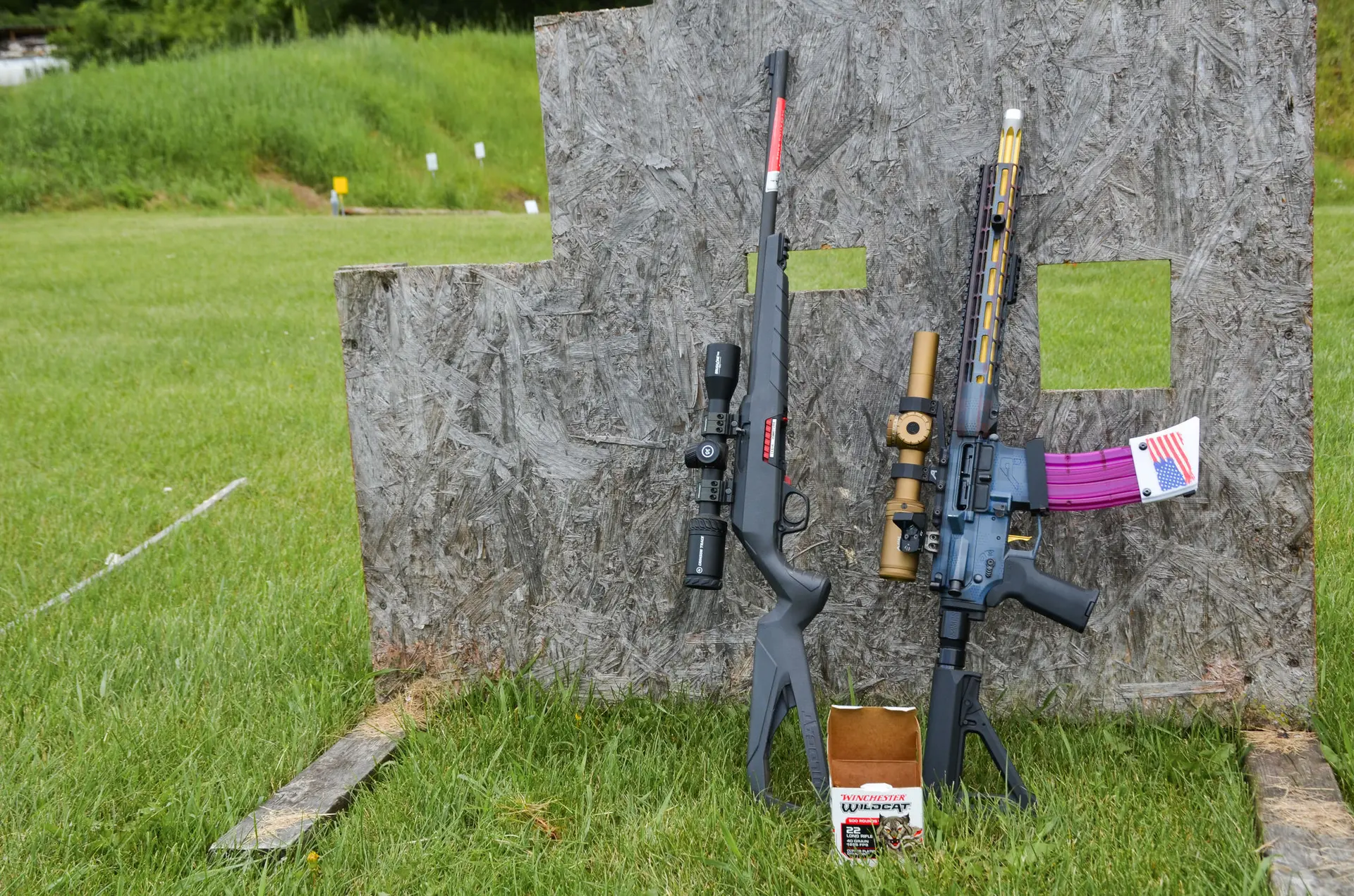 two guns leaning on a board