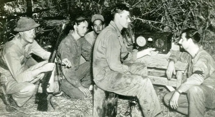 Weary US troops with an M1 rifle
