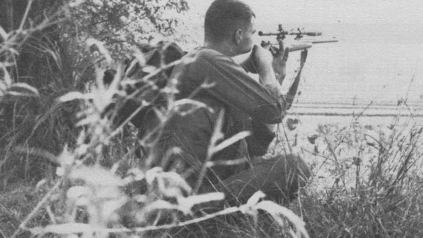 A USMC sniper with a Winchester Model 70 rifle